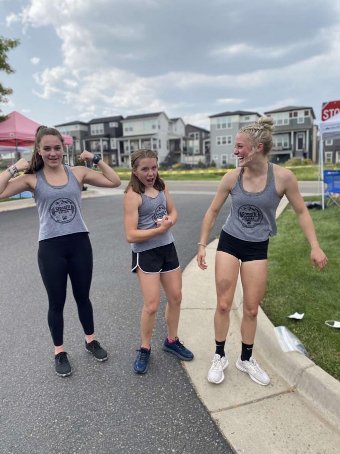 Pictured above Senior Rachel Pelino, 8th grader Cece Lengerich, and Sophomore Ally Post laugh together while posing for a picture. The three girls competed on a team together at the Girls Gone RX CrossFit competition in Denver.