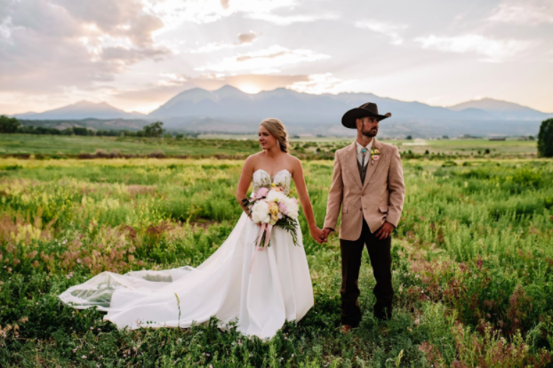 Above+Haley+Hume+and+Jacob+Hume+stand+together+on+their+wedding+day+at+Timber+Creek+Ranch+in+Salida%2C+on+June+19th+2021.+The+theme+was+classic+cowboy+complete+with+lush+greenery+and+gorgeous+mountains.+We+wish+them+all+the+best+here+at+SHS%21